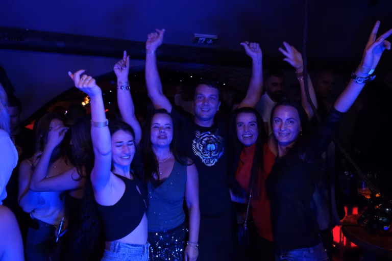 Hosté tančí s rukama nahoře v Lavish Lounge